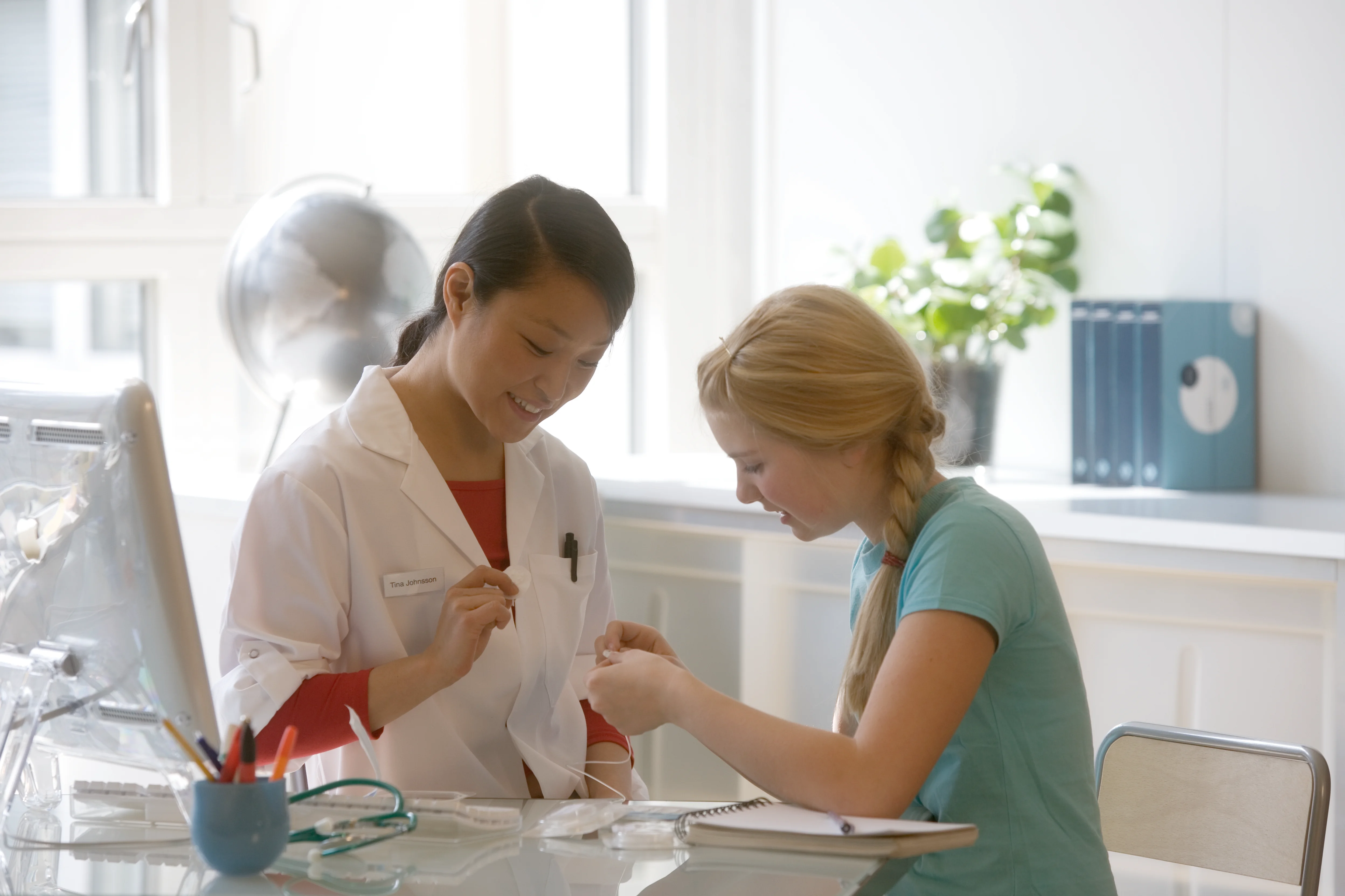 a woman and a woman looking at a paper