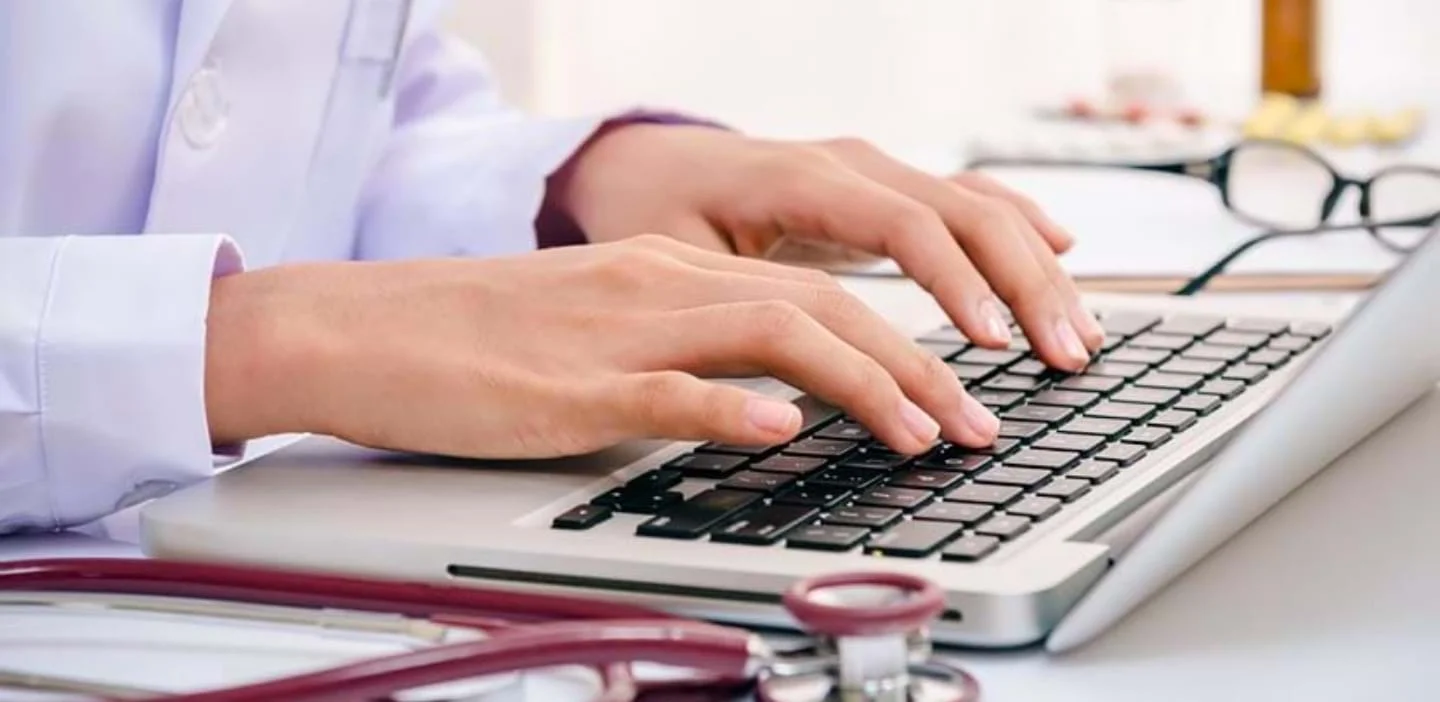 A person typing on a laptop