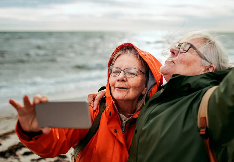 a man and woman looking at a laptop