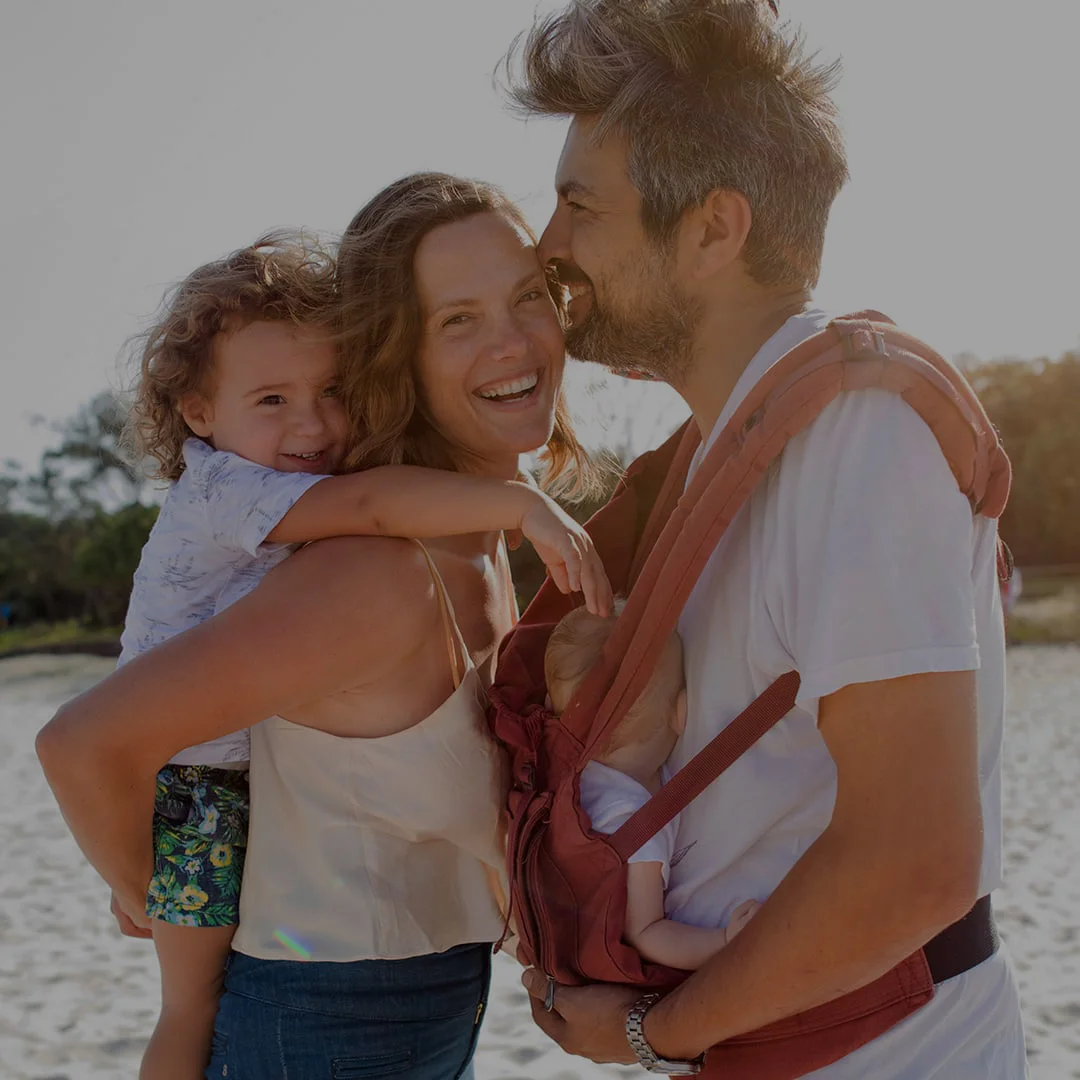 a man and woman holding a child