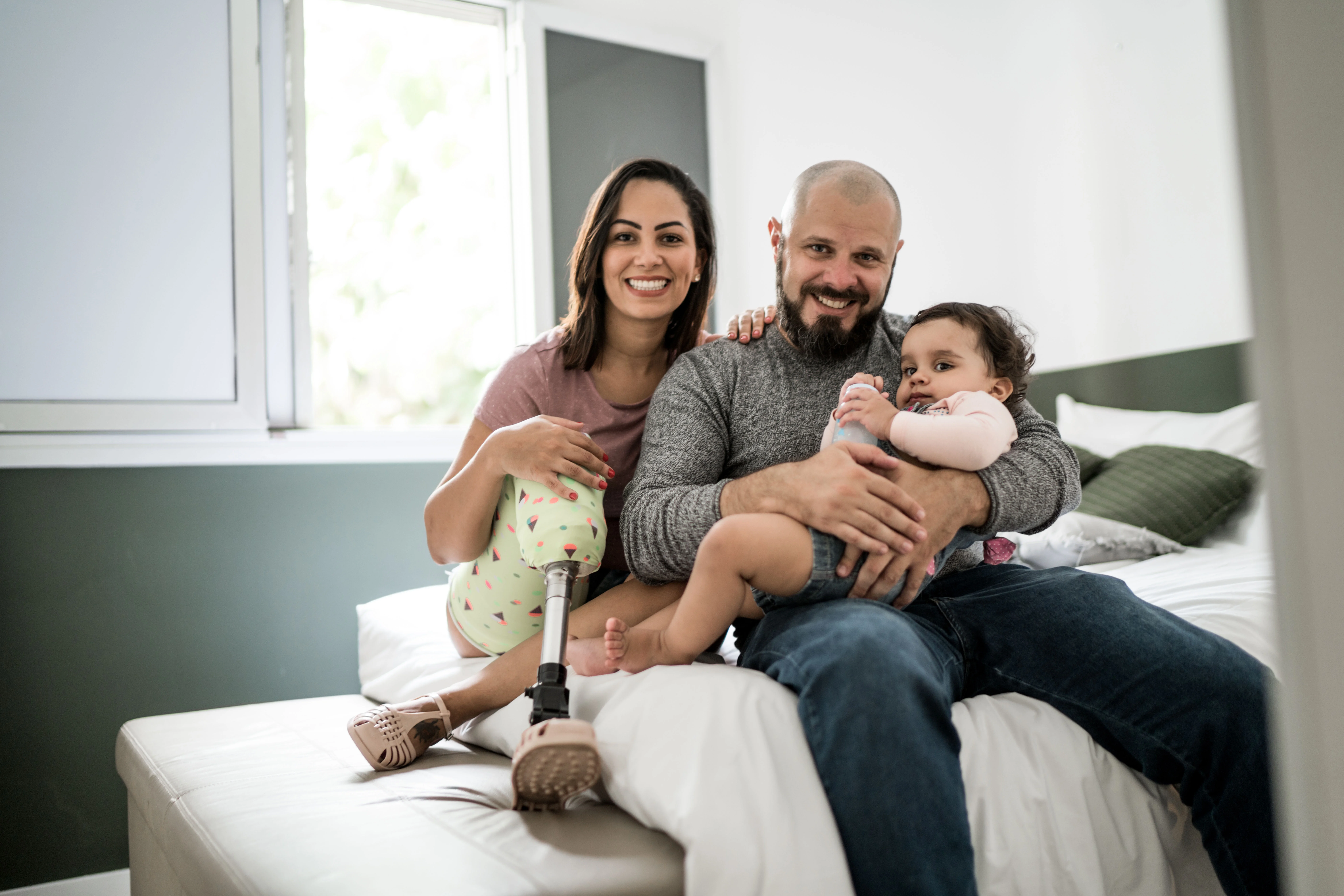a family sitting on a bed