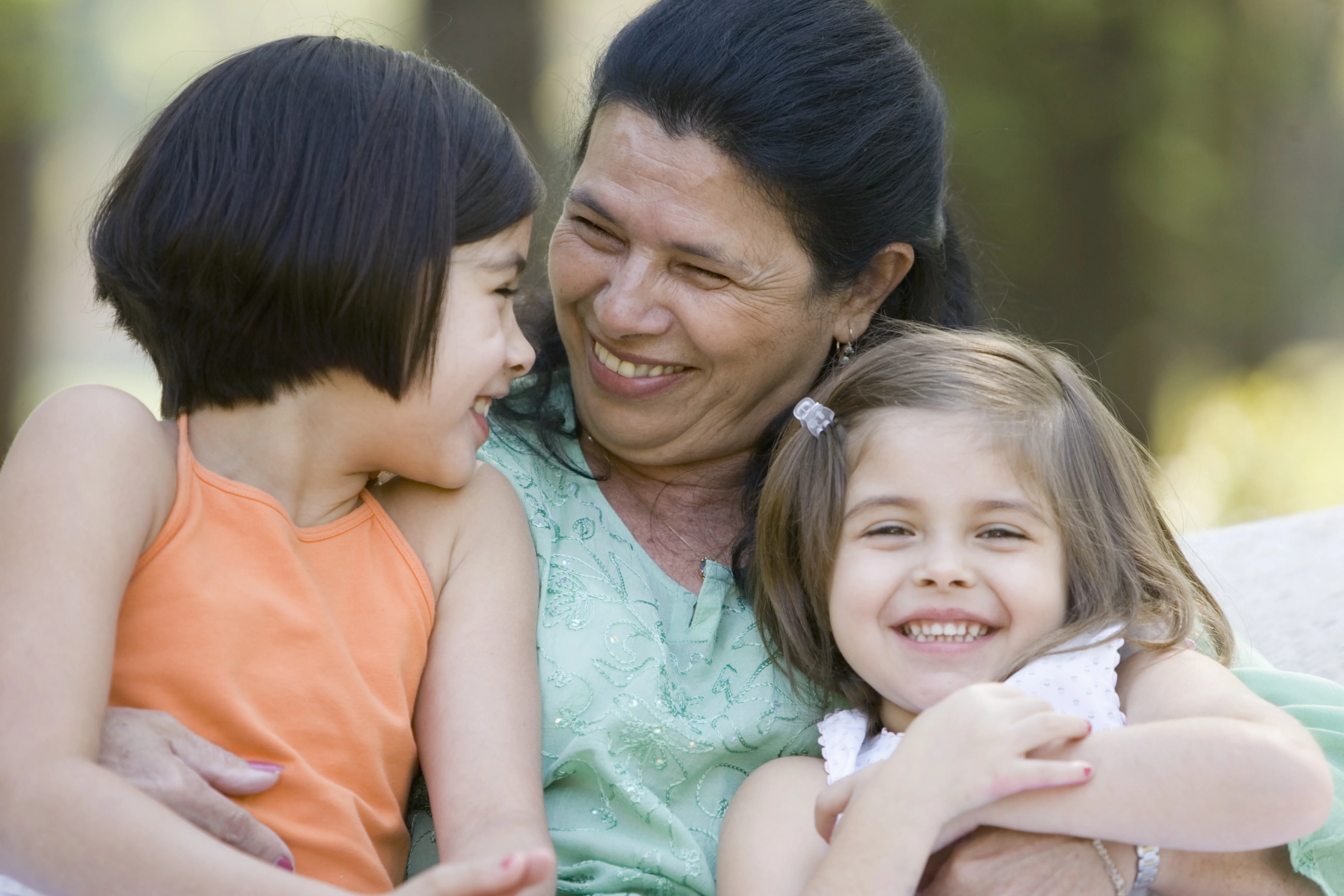 Smiling Grandmother holding her grandaughters
