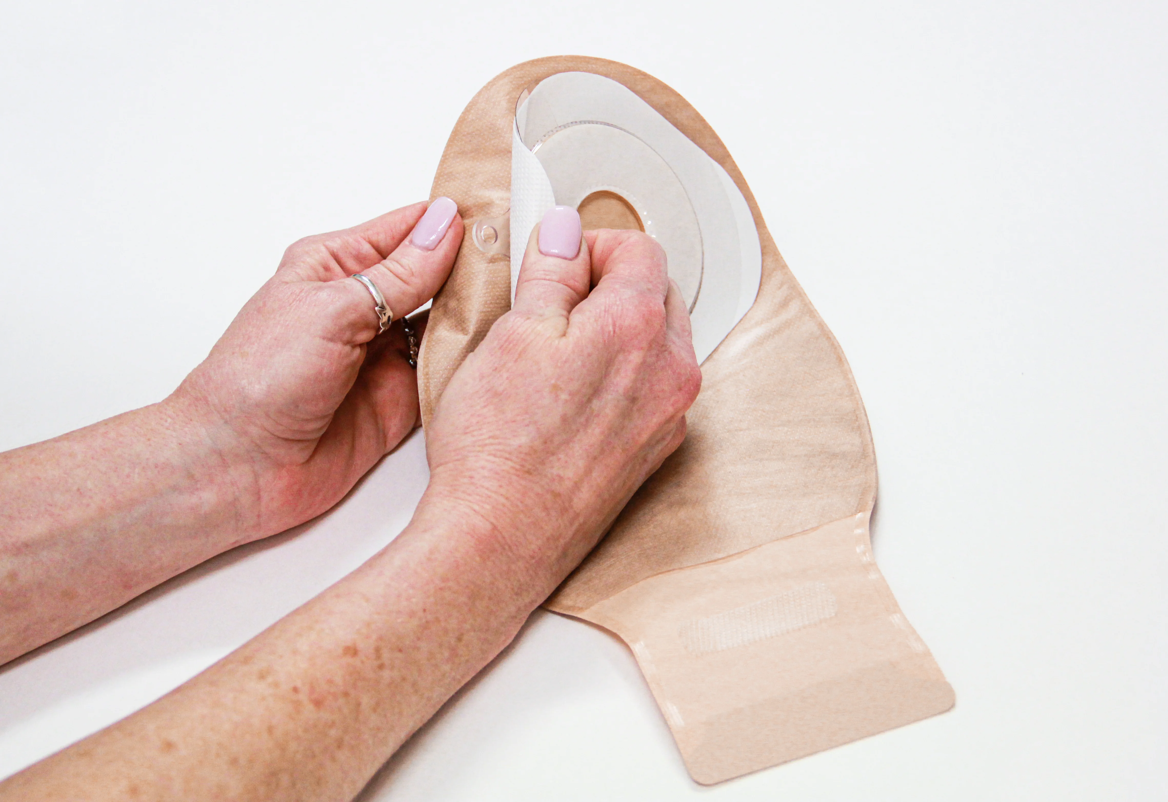 a person holding a roll of toilet paper