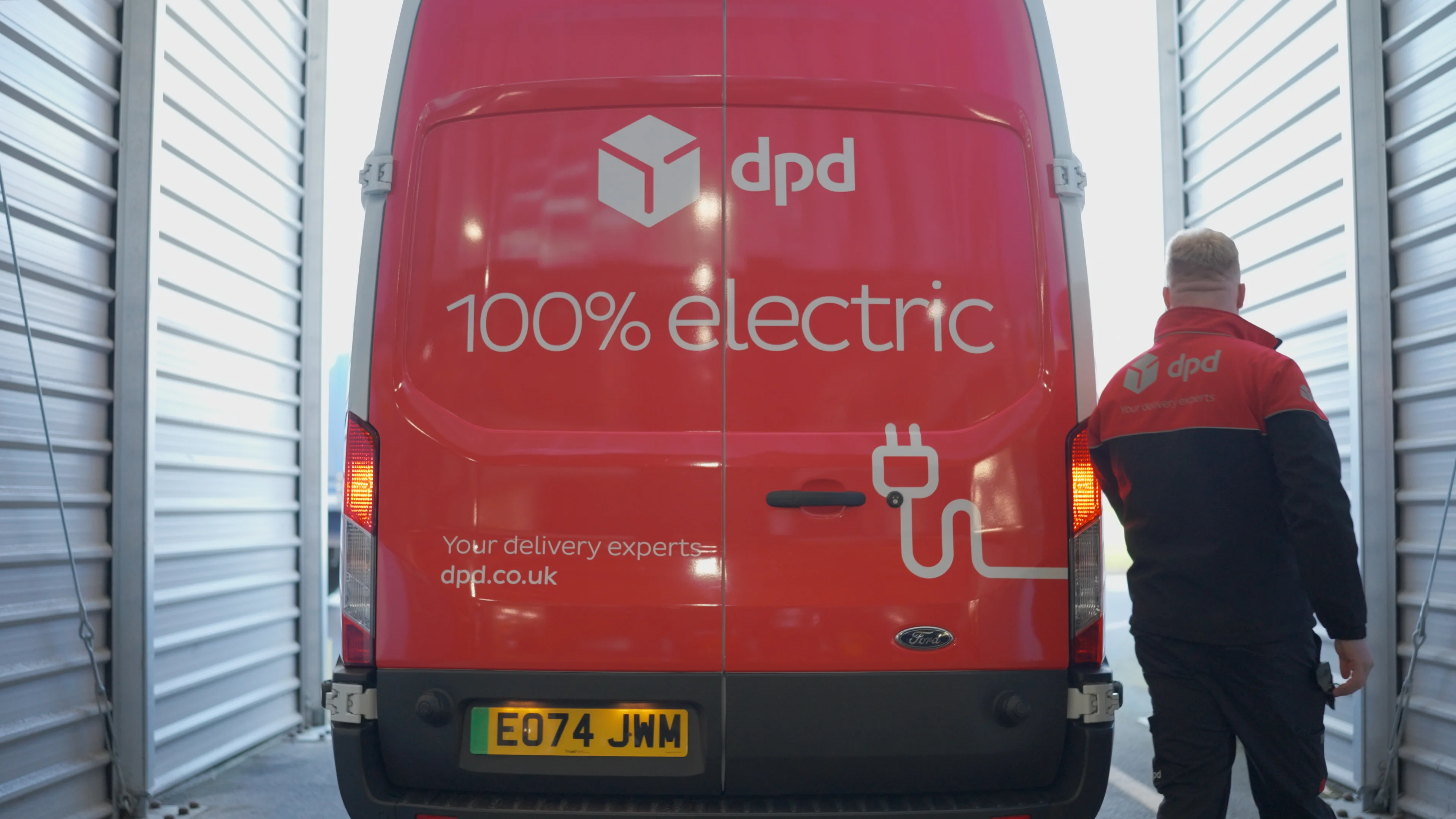 Woman in a pink top accepting a delivery