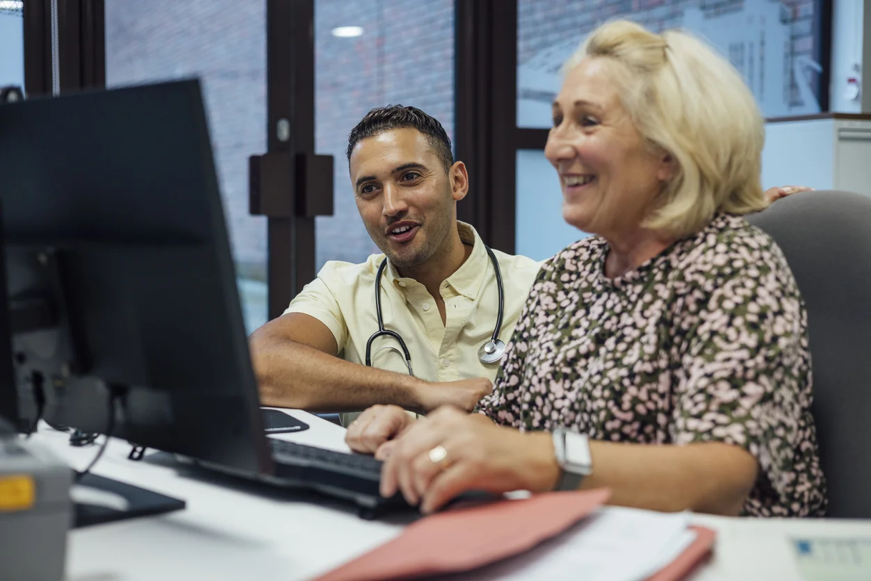 a man and a woman looking at a computer screen