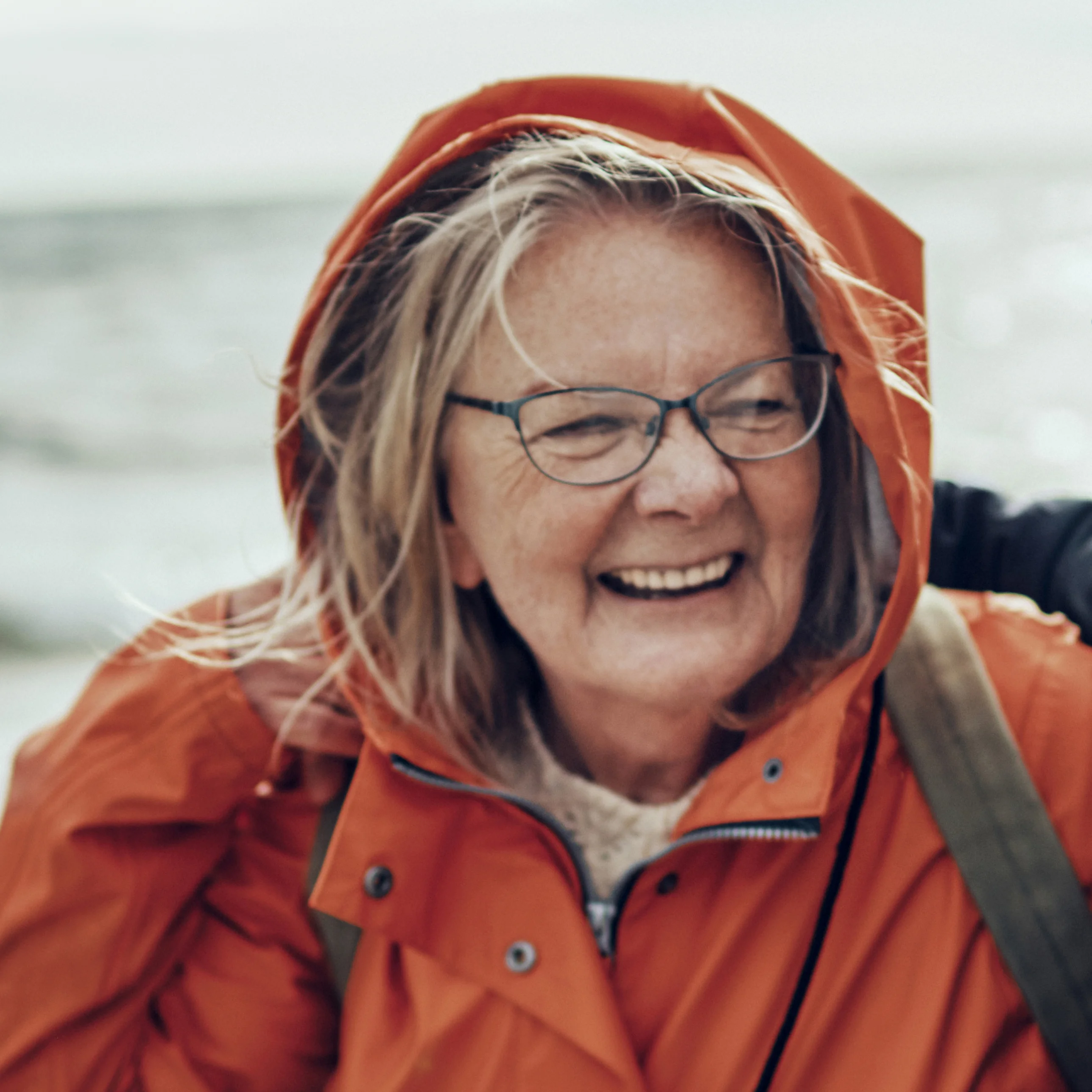 A smiling woman on a beach